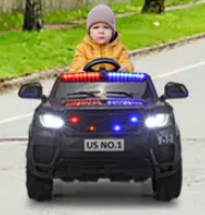A kid is riding the ride on police car.